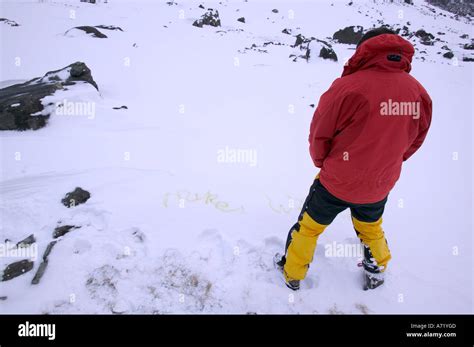 a man writing his name in the snow in pee, Cuillin mountains, Isle of