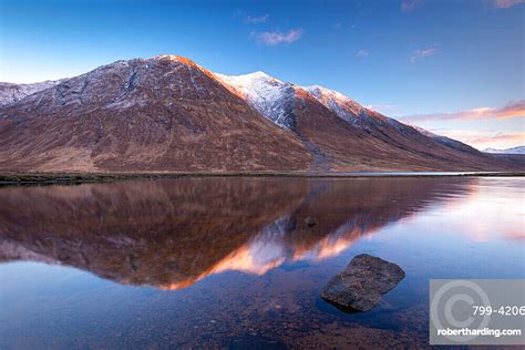 Snow Capped Highlands Mountains Reflected Stock Photo