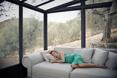 Woman Sleeping On Sofa With Throw Pillows · Free Stock Photo