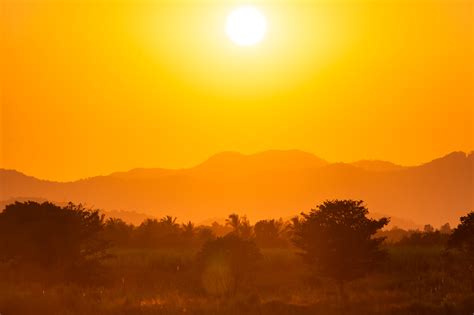 Bright yellow sunset in hills free image