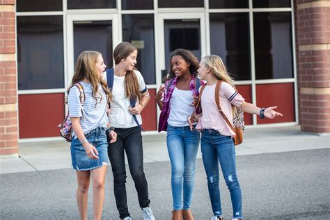 Candid Photo Of A Group Of Teenage Girls Socializing Laughing A