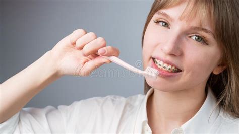 Portrait Of A Caucasian Woman With Braces On Her Teeth Holding A Toothbrush Stock Photo Image