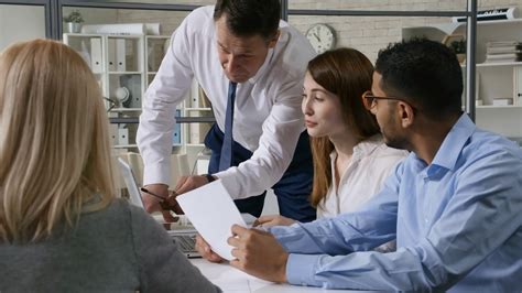 Meeting planners and other meeting professionals may use the term meeting to denote an event booked at a hotel, convention center or any other venue dedicated to such gatherings. Senior business mentor showing something on laptop and ...
