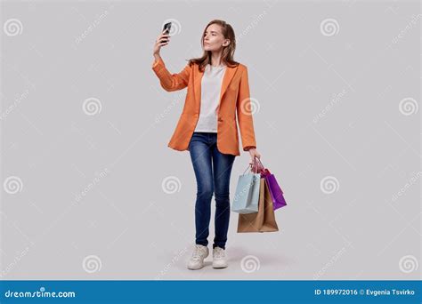 Satisfied Girl Takes A Selfie With Purchases In Her Hands Online