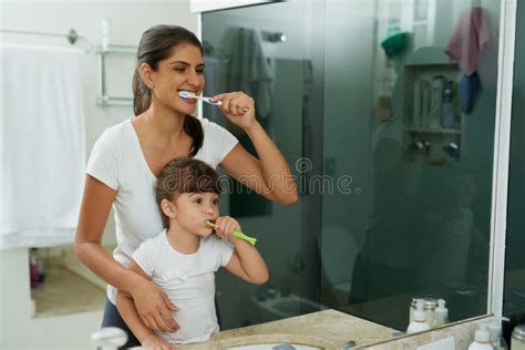 Love Is Helping Them Learn Healthy Dental Habits Shot Of A Mother And Daughter Brushing Their