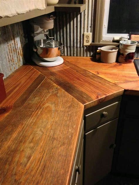 Reclaimed wood is the best wood to use for kitchen countertops in country and rustic kitchens. I like the backsplash with the raw edge | Rustic kitchen ...