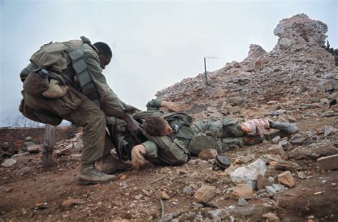 A Us Marine Dragging A Wounded Marine To Cover During The Battle For