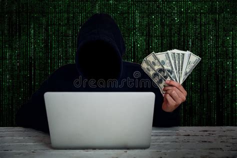 Hacker Wearing Black Hooded With Computer Hacking Data And Showing