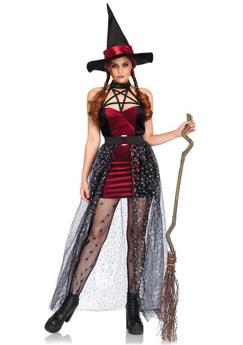 A Woman In A Witch Costume Holding A Broom