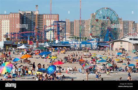 Coney Island Beach With The Boardwalk And Luna Park Rides In The