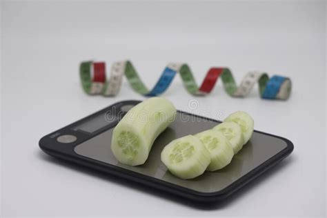 Cucumbers On The Scales Weight Loss Diet And Weight Control Still Life With Healthy Food And