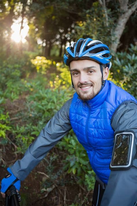 Portrait Of Male Mountain Biker With Bicycle In The Forest Stock Photo