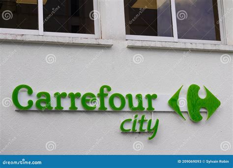 Carrefour City Brand Logo And Text Sign Front Of Town Store Entrance
