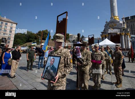 Honor guard soldiers hold a portrait of the deceased Sergii Ilnitskiy