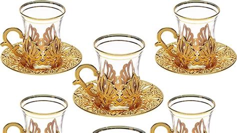 Six Glass Cups And Saucers With Gold Designs
