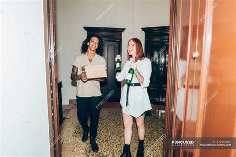Friends With Beer Bottle And Pizza Boxes At Entrance Of Home — Multi Ethnic Group Friendship