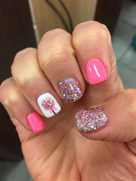 Apply glitter nail polishes on one or two nails. Christmas nail design. Ornament pink glitter gel shellac ...
