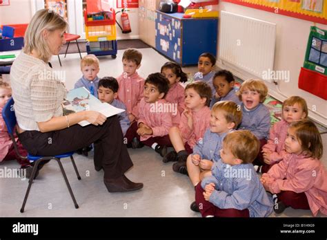 Teacher Reading To Nursery School Children Stock Photo Royalty Free