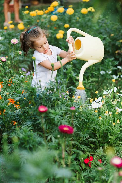 Child Watering Flowers By Dejan Ristovski