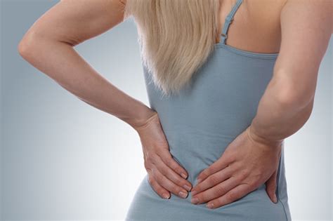 A series of muscles and ligaments in your back hold the bones of your spinal column in. Back Pain Athletic Fitness Woman Rubbing The Muscles Of ...