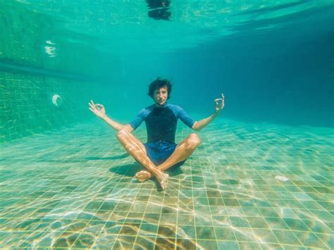 Premium Photo Young Man In Black Bikini In Yoga Position Underwater