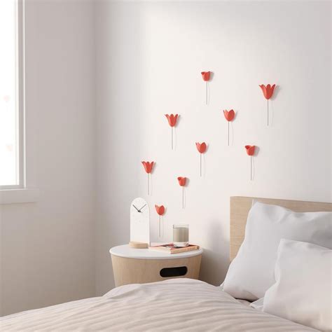 Another features a wire frame on a brick wall with terra cotta pots hung on it. Wall decoration in relief coral flower - 3D tulips - Umbra