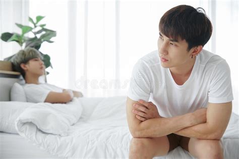 Portrait Of Young Asian Gay Couple Lying On Bed With Rainbow Flag Symbolic Of Lgbt Two Cute Men