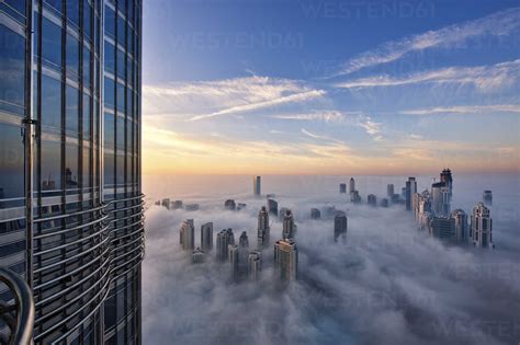 Cityscape With Illuminated Skyscrapers Above The Clouds In Dubai