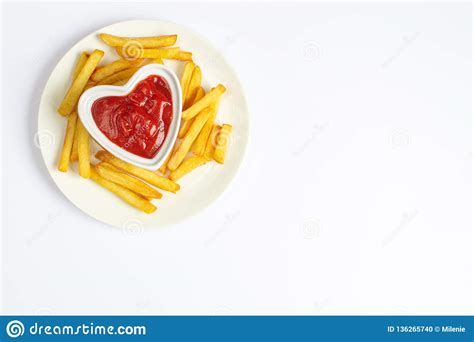 Tasty French Fries On White Plate With Heart Pattern Of Ketchup Stock