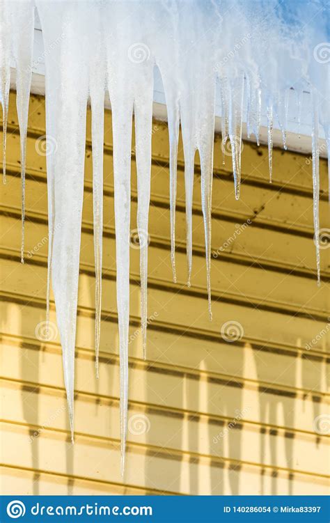 The Icicles Hanging From The Rim Of The Roof Stock Photo Image Of
