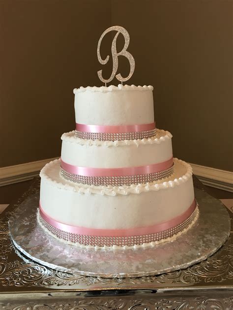 If you buy the right kind of trim, you don't need to do anything more than press the trim into the icing. Buttercream Tiered cake with pink ribbon and rhinestone ...