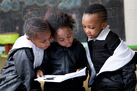 School Kids Reading In The Classroom Stock Photo Dissolve