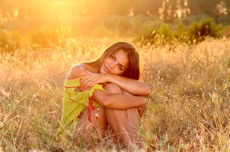 Beautiful Girl Sitting On The Grass In The Sunset Free Image Download