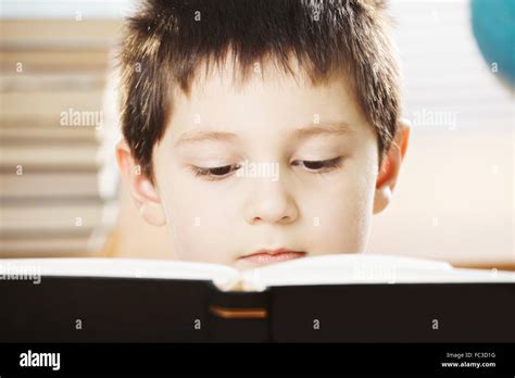 Serious Caucasian Boy Reading Book Closeup Stock Photo Alamy