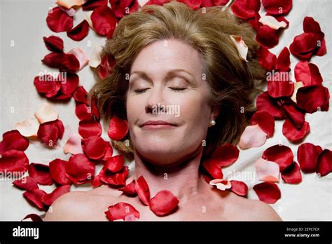 High Angle View Of A Mature Woman Lying On A Massage Table With Rose