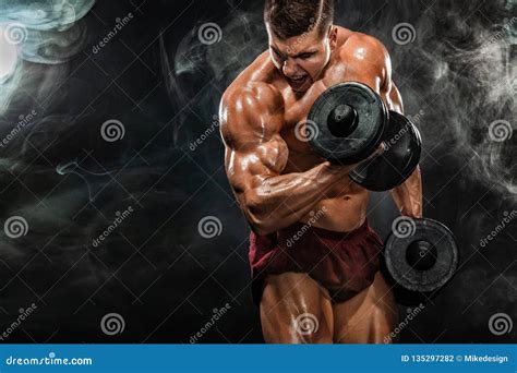Brutal Strong Muscular Bodybuilder Athletic Man Pumping Up Muscles With