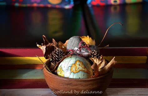 A Wooden Bowl Filled With Lots Of Different Types Of Decorations On Top