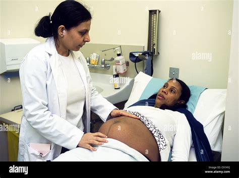 Midwife Examining Pregnant Woman At Anti Natal Clinic Stock Photo Alamy