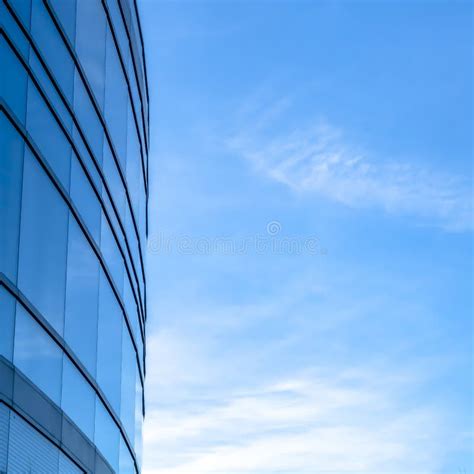 Blue Glass Windows Of Building Against Bright Sky Stock Photo Image