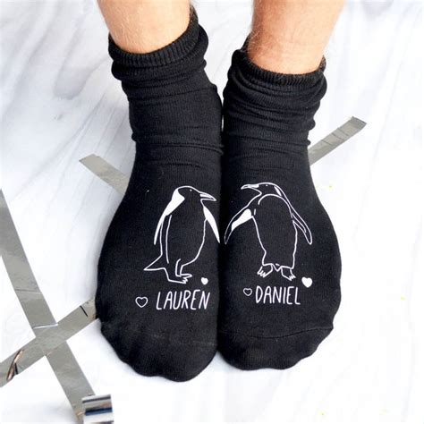 Two Pairs Of Black Socks With White Penguins On Them And The Words Lauren And Danielle