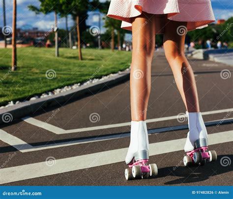 Close Up Of Beautiful Female Legs On Roller Skates In A Steep Summer