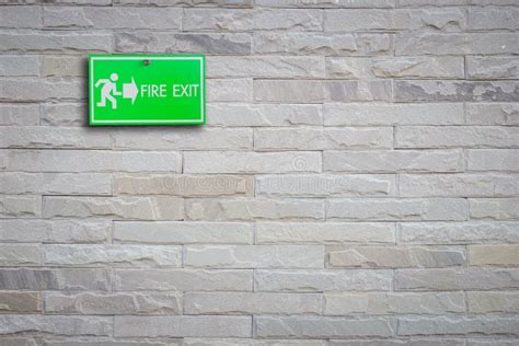 Green Fire Exit Sign On Stone Wall Stock Photo Image Of Alarm Safety