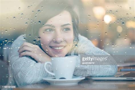 Young Woman Looking Through Window On Rainy Day Photos And Premium High