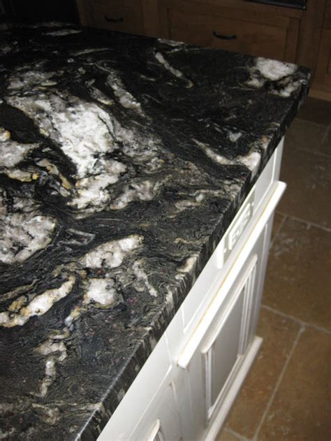 Tan brown granite is dark brown background kitchen countertop with black, dark brown, burnt orange, gray tones, and red hues. Titanium Granite Countertop Home Design Ideas, Pictures ...