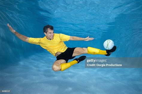 Underwater Soccer Player Kicking A Ball High Res Stock Photo Getty Images