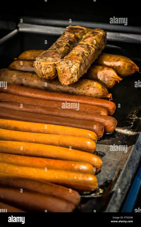Rows And Stacks Of Grilling Hot Dogs Italian Sausages And Bratwurst On
