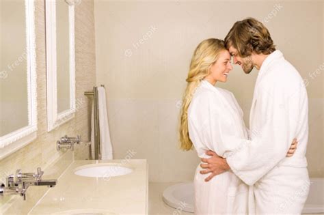Premium Photo Cute Couple Embracing In Bath Robe In The Bathroom At Home