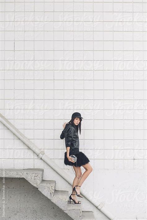 a woman walking down a flight of stairs dressed in all black by stocksy contributor a model