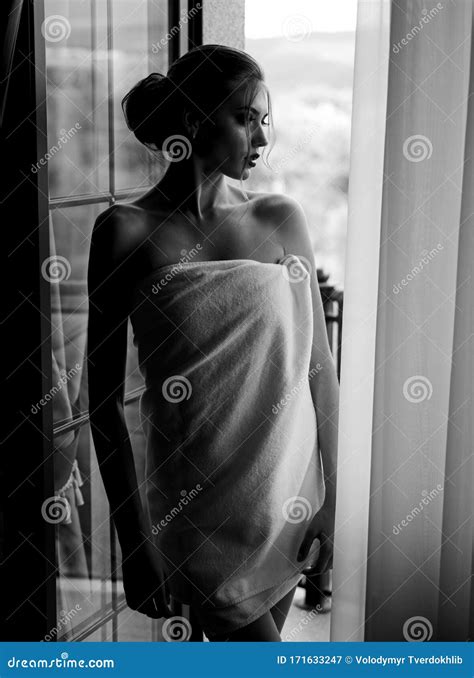Sensual Young Woman Wrapped In Towel After Having A Shower Standing