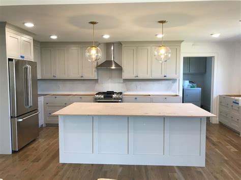Glass slipper has a definite blue undertone, but the gray in it keeps it neutral. Inset shaker cabinets painted in Benjamin Moore Revere ...